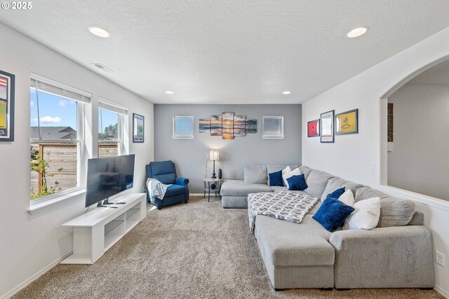 764 Seacrest Dr, Bandon, OR 97411 - carpeted living area featuring arched walkways, recessed lighting, baseboards, and a textured ceiling