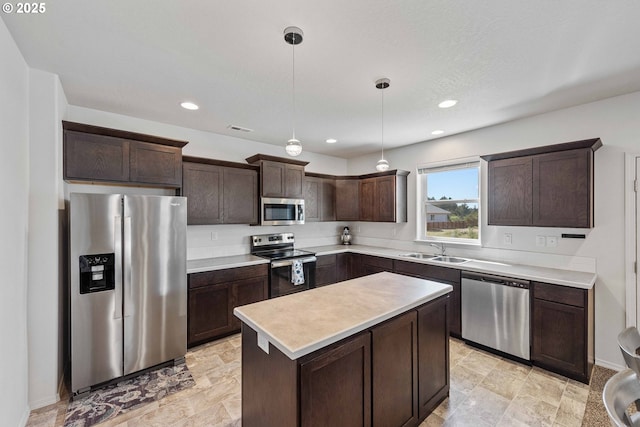 764 Seacrest Dr, Bandon, OR 97411 - kitchen with stainless steel appliances, a sink, dark brown cabinetry, light countertops, and decorative light fixtures