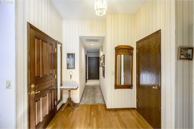 hallway with light hardwood / wood-style flooring