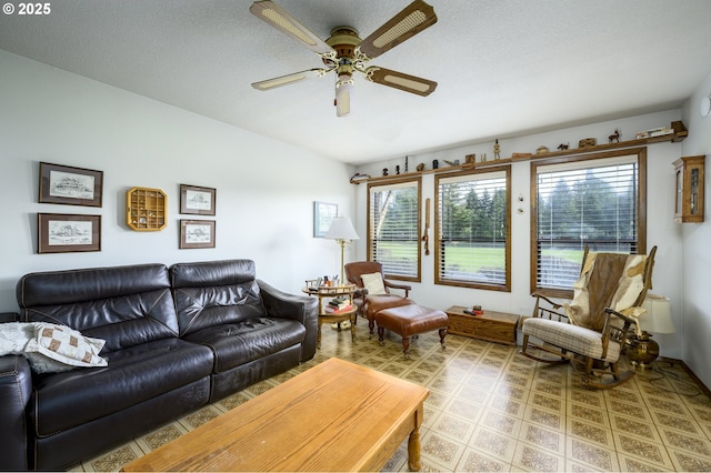 living room featuring ceiling fan, a textured ceiling, and a wealth of natural light