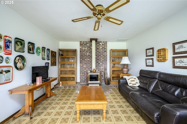 living room with a wood stove and ceiling fan