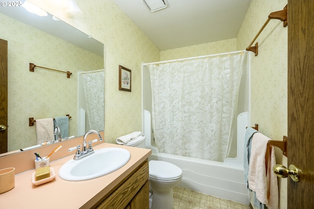 full bathroom with vanity, shower / tub combo, and toilet