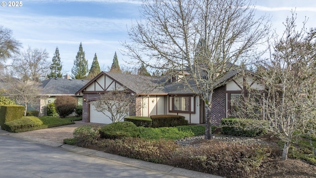 english style home featuring a garage