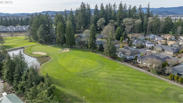 birds eye view of property with a water and mountain view