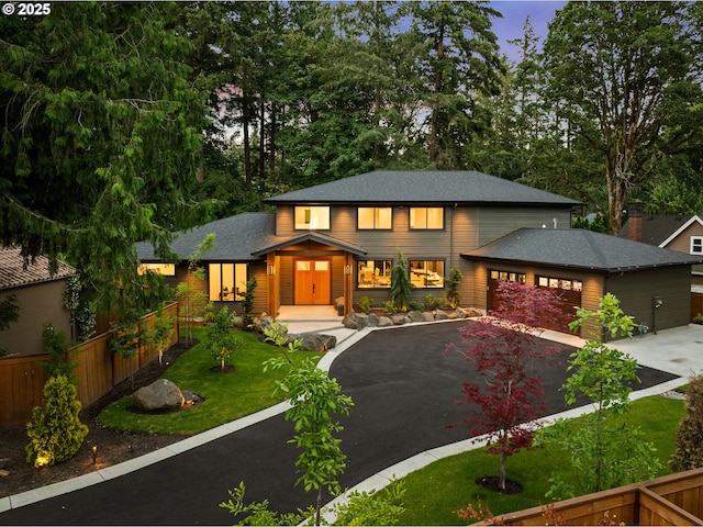 view of front of house with asphalt driveway, a garage, and a shingled roof