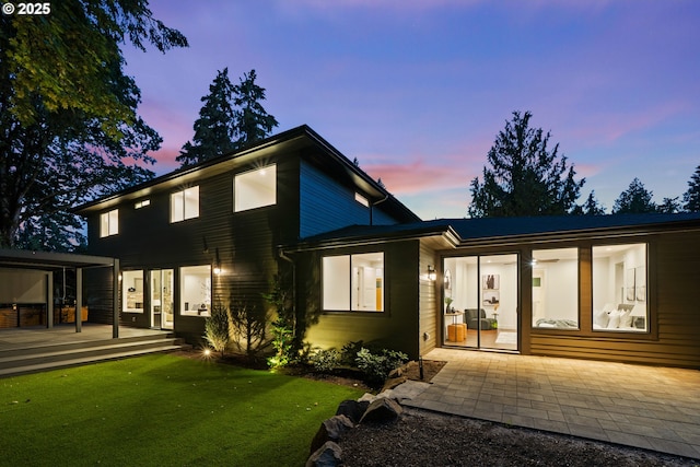 back of property with a deck, a lawn, and french doors