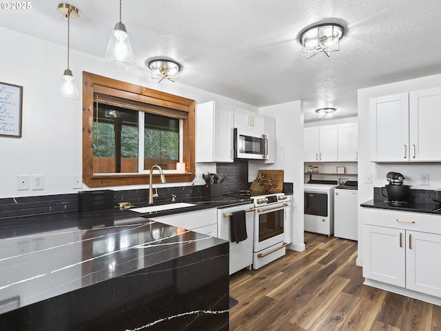 54934 E Kirkwood Dr, Sandy, OR 97055 - kitchen featuring washing machine and dryer, dark countertops, dark wood-type flooring, a textured ceiling, and white cabinets