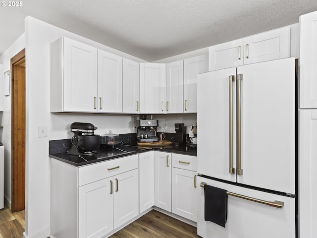 54934 E Kirkwood Dr, Sandy, OR 97055 - kitchen featuring high end fridge, dark wood-type flooring, dark countertops, white cabinets, and a textured ceiling
