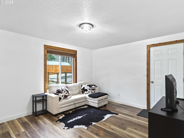 54934 E Kirkwood Dr, Sandy, OR 97055 - living room with dark wood-type flooring, a textured ceiling, and baseboards