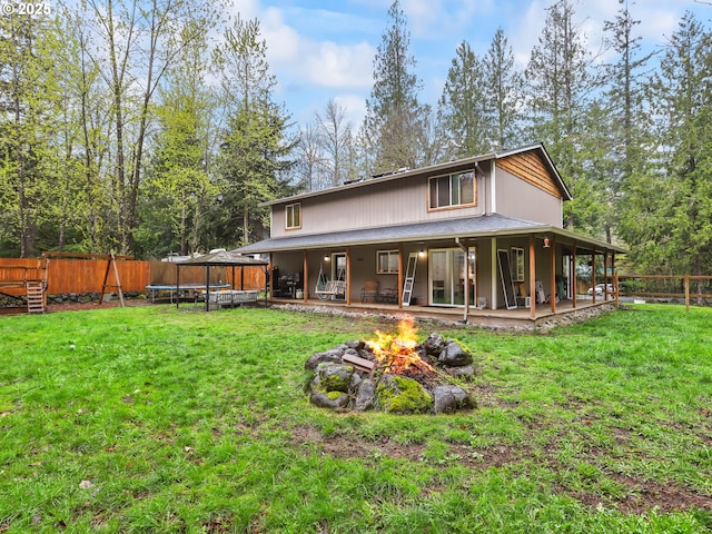 54934 E Kirkwood Dr, Sandy, OR 97055 - rear view of house featuring a trampoline and an outdoor fire pit