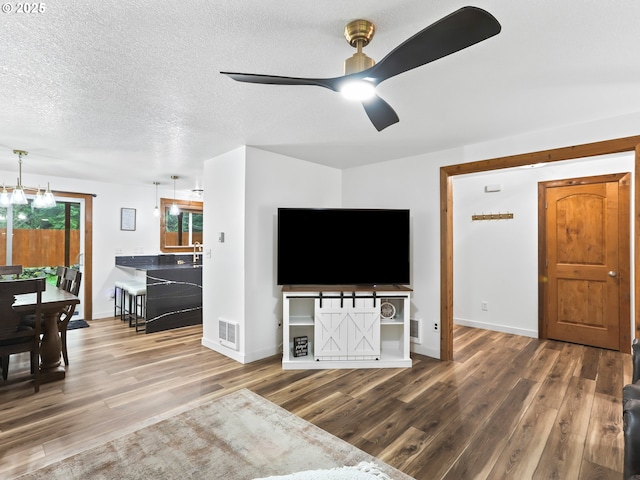 54934 E Kirkwood Dr, Sandy, OR 97055 - living area featuring wood finished floors, ceiling fan, baseboards, and a textured ceiling