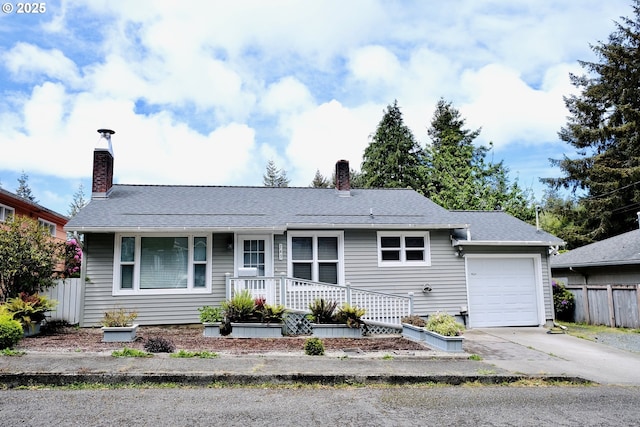 single story home featuring a chimney, a garage, driveway, and fence