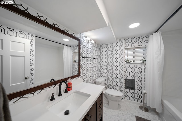 bathroom with vanity, toilet, and shower / bath combination with curtain
