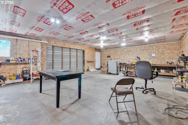 playroom with concrete flooring, a garage, and a workshop area