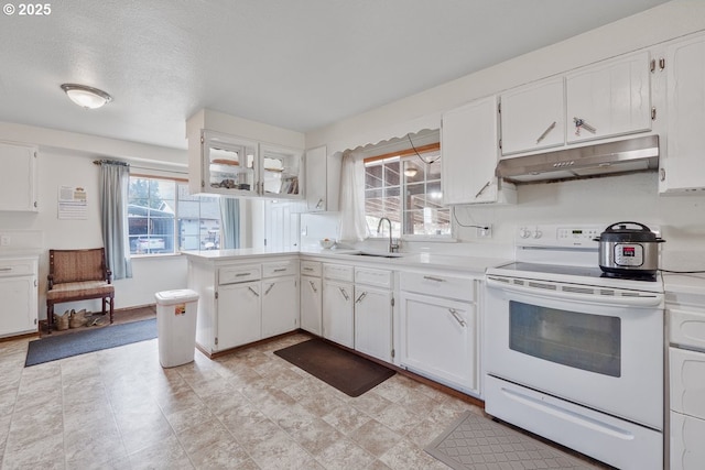 kitchen with white cabinetry, a sink, white electric range oven, and under cabinet range hood