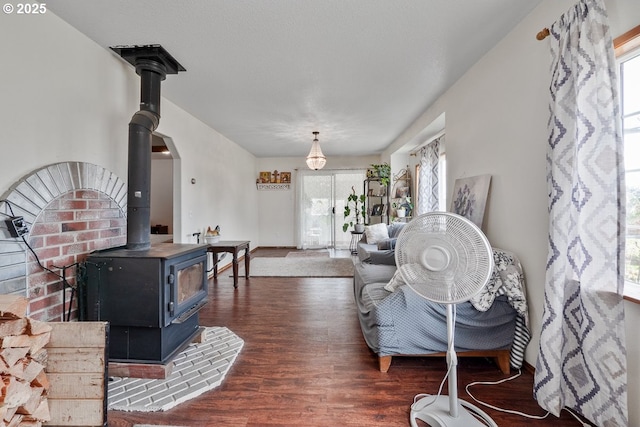 living room with wood finished floors and a wood stove