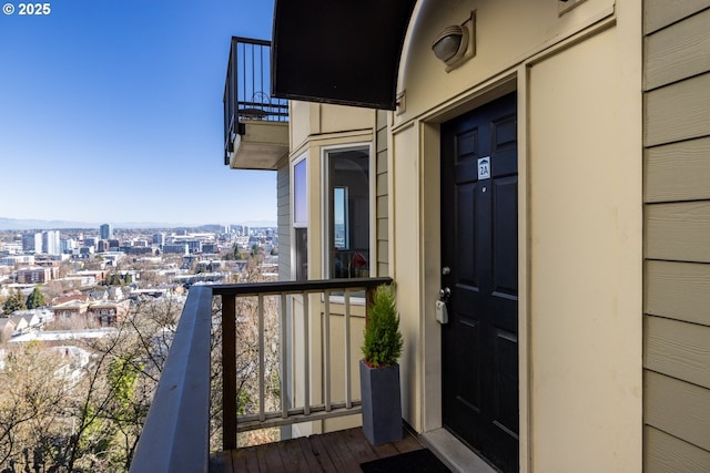 property entrance with a view of city and a balcony