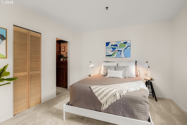 bedroom with a closet, carpet flooring, and baseboards