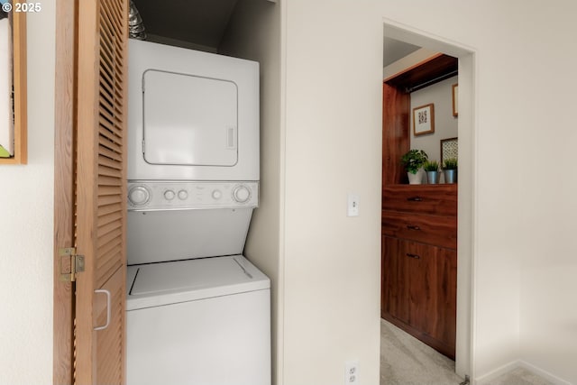 washroom with stacked washer / dryer, laundry area, and carpet flooring