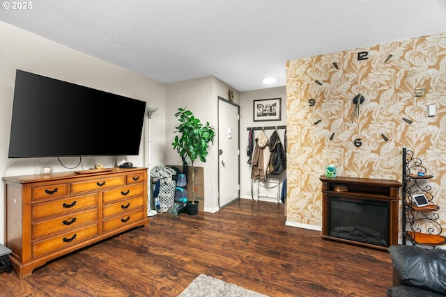 living room with a fireplace, dark hardwood / wood-style flooring, and a textured ceiling