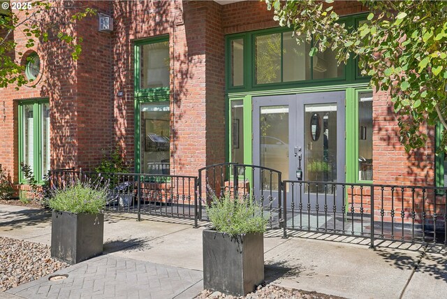109 SW Gibbs St, Portland, OR 97239 - view of exterior entry with brick siding and french doors