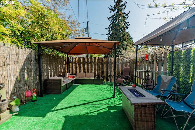 9023 SE Ankeny St, Portland, OR 97216 - view of patio featuring an outdoor living space with a fire pit, a gazebo, and a fenced backyard