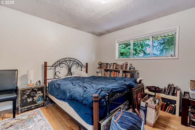 9023 SE Ankeny St, Portland, OR 97216 - bedroom with a textured ceiling and wood finished floors