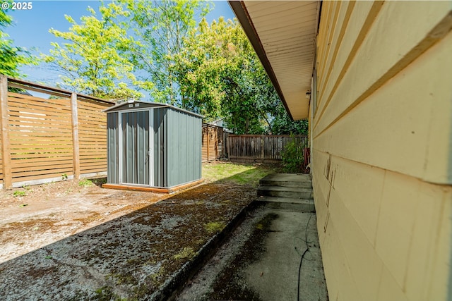 9023 SE Ankeny St, Portland, OR 97216 - view of side of home featuring a storage shed, an outbuilding, and a fenced backyard
