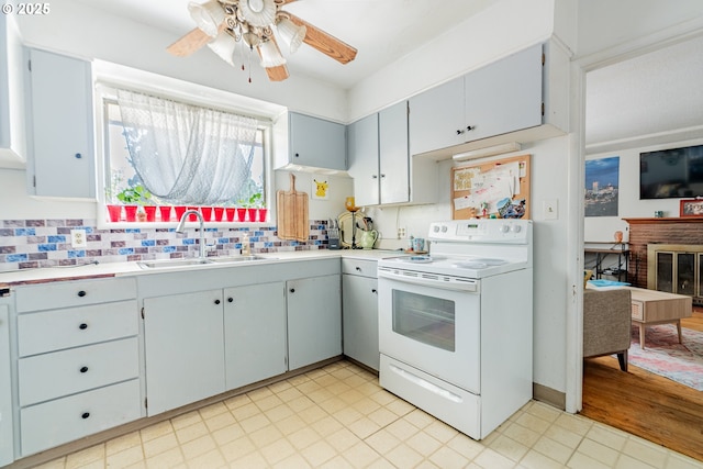 9023 SE Ankeny St, Portland, OR 97216 - kitchen featuring tasteful backsplash, light countertops, a sink, white electric range, and a ceiling fan