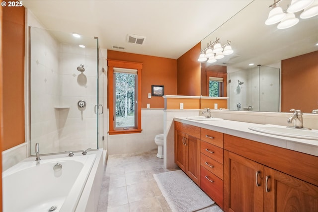 full bathroom featuring tile walls, vanity, plus walk in shower, tile patterned floors, and toilet