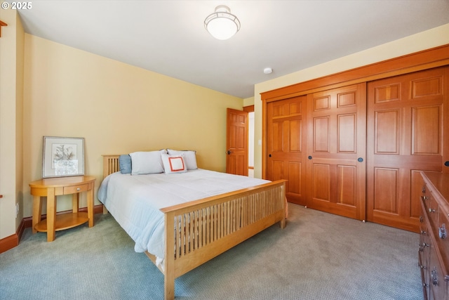 bedroom with light colored carpet and a closet