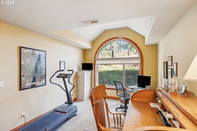 carpeted office space featuring lofted ceiling