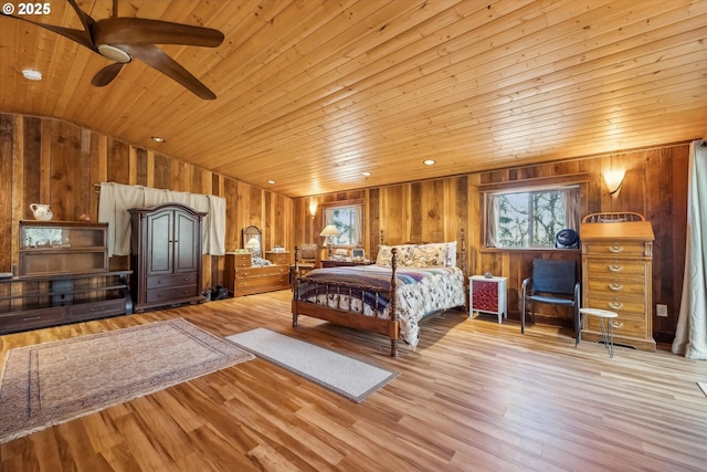 bedroom featuring vaulted ceiling, wood walls, wood ceiling, and light hardwood / wood-style floors