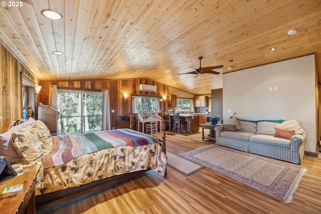 bedroom with vaulted ceiling, an AC wall unit, wooden walls, wood ceiling, and light hardwood / wood-style flooring