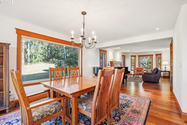 dining area with hardwood / wood-style floors and a chandelier