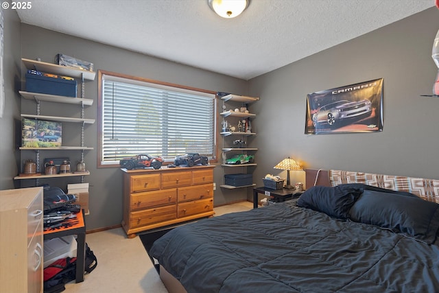 bedroom featuring light carpet and a textured ceiling