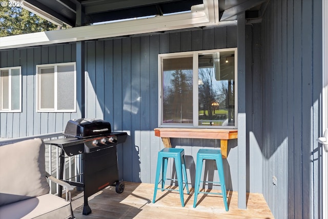 exterior space featuring area for grilling, a wooden deck, and exterior bar