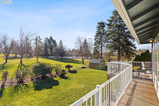 view of yard featuring a wooden deck and a storage shed