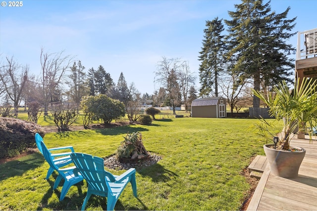 view of yard featuring an outdoor fire pit and a storage unit