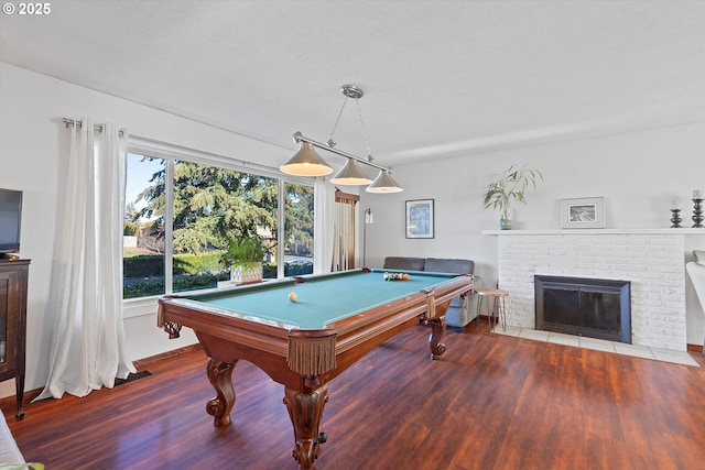 recreation room featuring a fireplace, plenty of natural light, billiards, and wood-type flooring