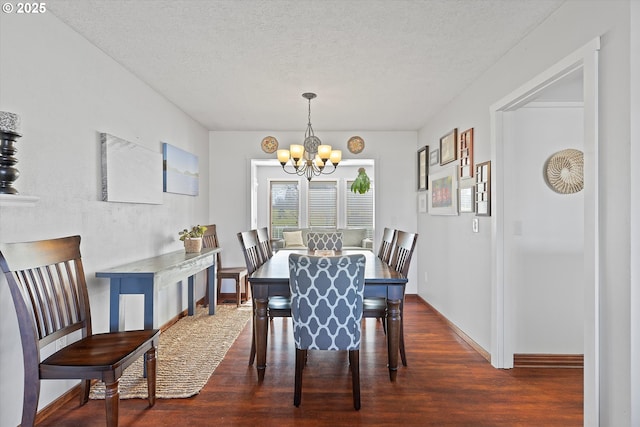 dining area featuring an inviting chandelier, dark hardwood / wood-style flooring, and a textured ceiling