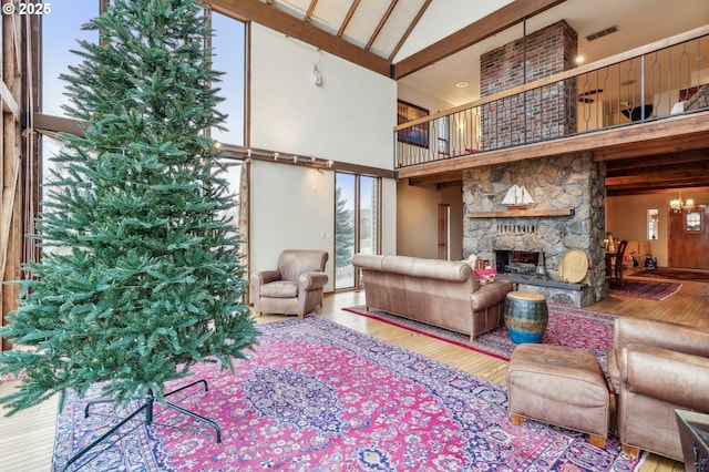 living room with a fireplace, high vaulted ceiling, and wood-type flooring