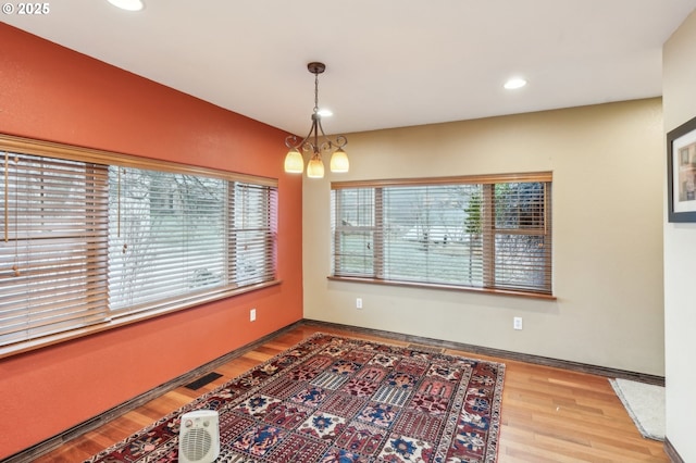 dining area with a chandelier and hardwood / wood-style floors