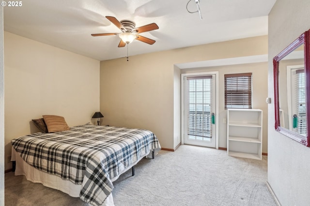 bedroom featuring access to outside, light colored carpet, and ceiling fan