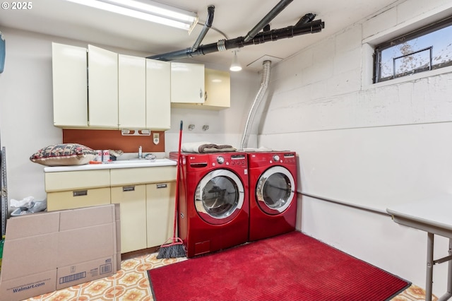 laundry room with separate washer and dryer, cabinets, and sink