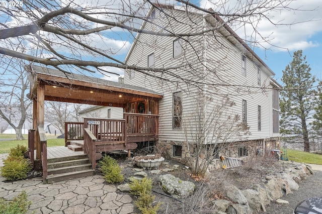 back of property with a wooden deck