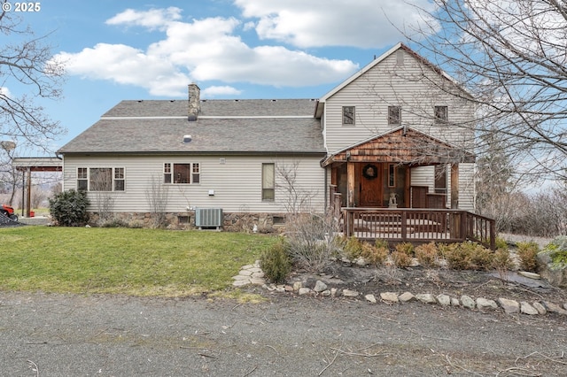 exterior space featuring central AC and a front lawn