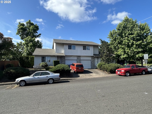 14818 NE Fremont St, Portland, OR 97230 - view of front of house featuring a garage and stone siding