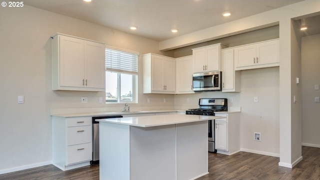 274 Greencrest St, Salem, OR 97301 - kitchen featuring stainless steel appliances, dark wood-style flooring, white cabinets, a center island, and light countertops