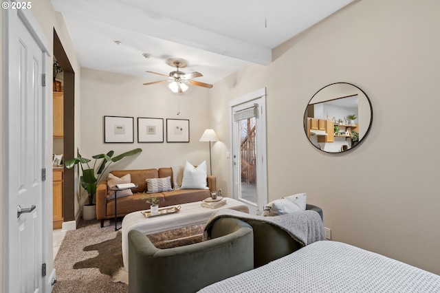 bedroom with ceiling fan, beam ceiling, and access to exterior